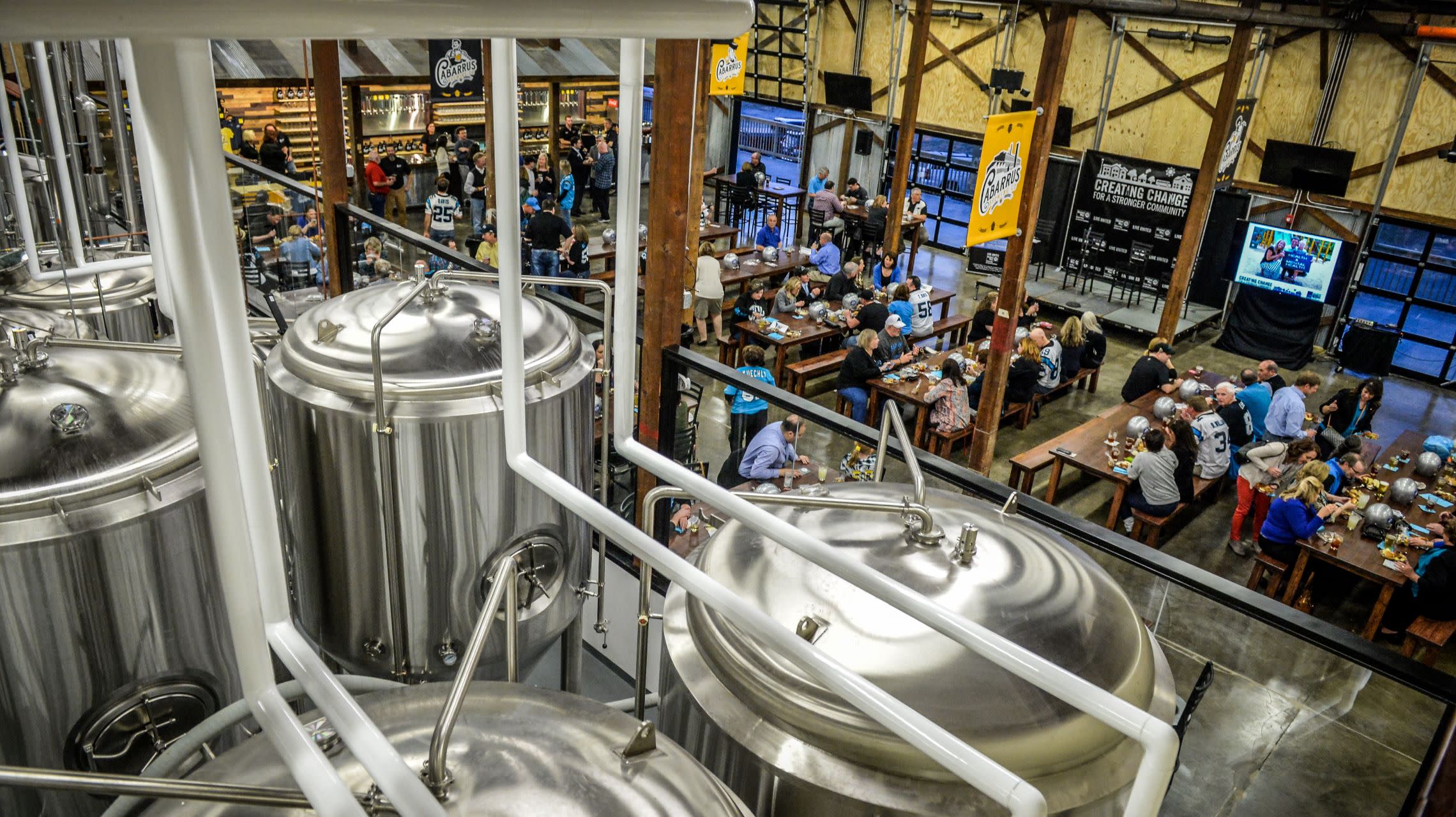 group inside brewery taproom