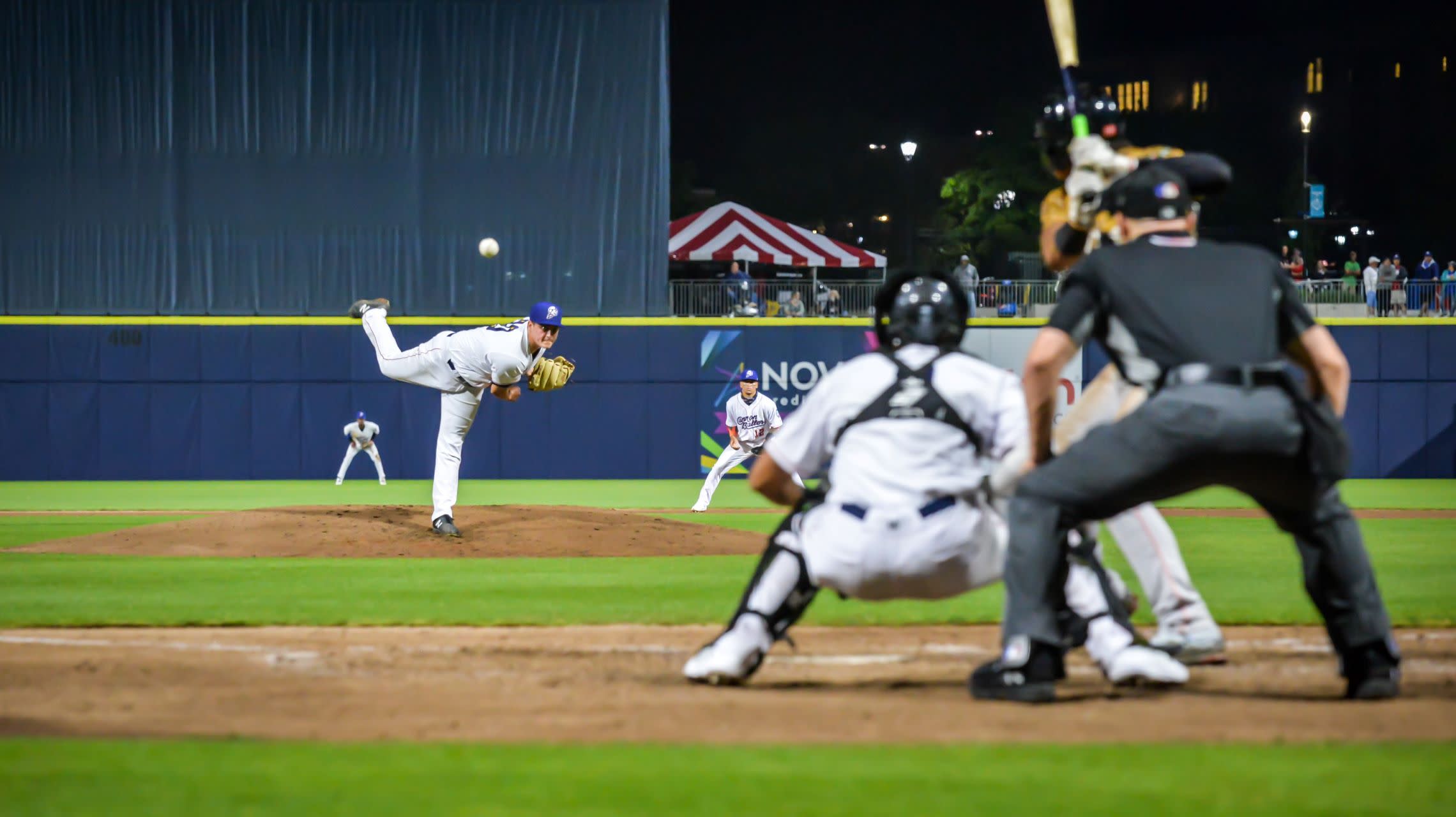 pitcher throws ball during baseball game