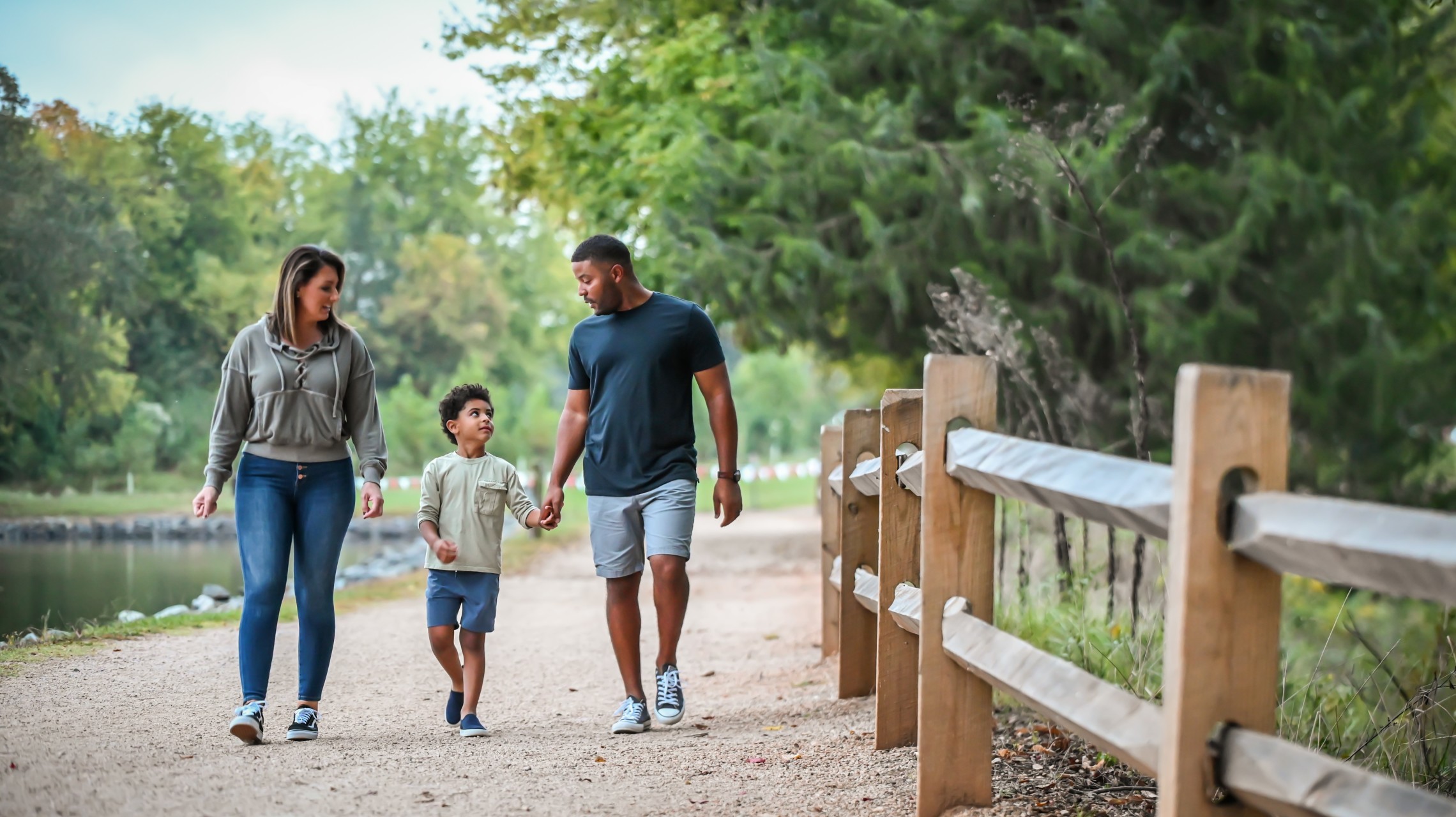 family walking next to lake