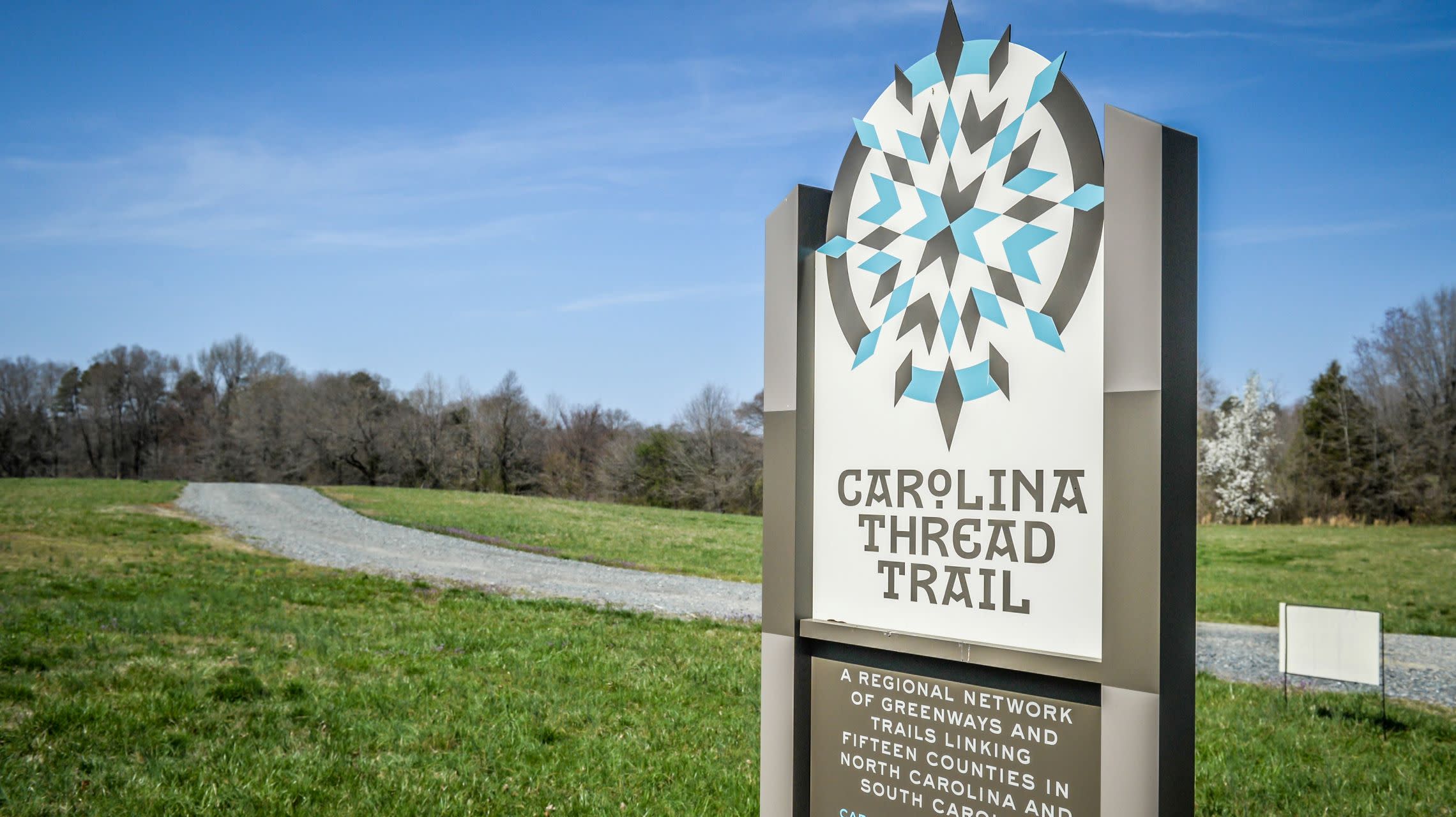 sign alongside outdoor trail