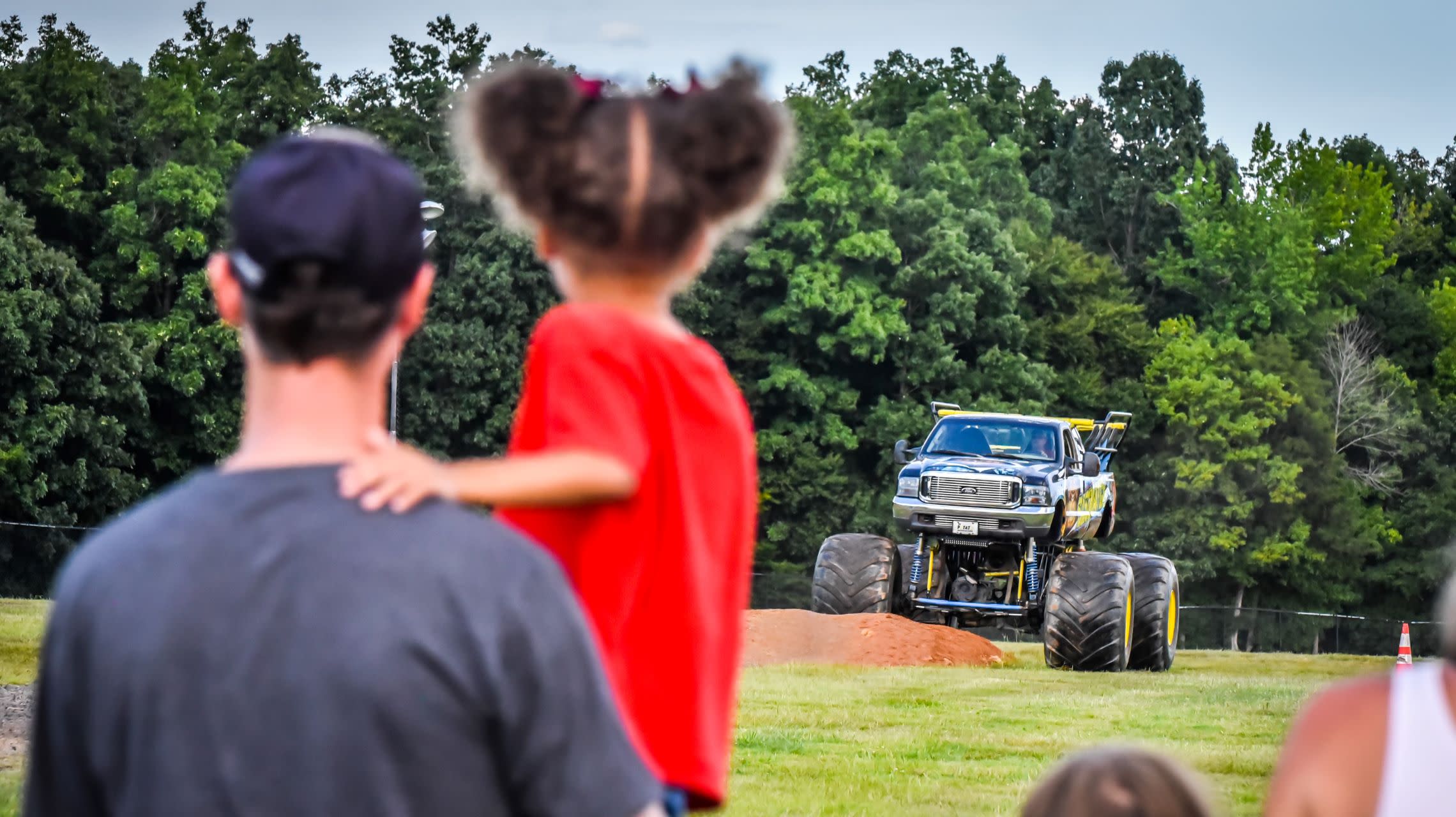 father and daughter watch monster truck