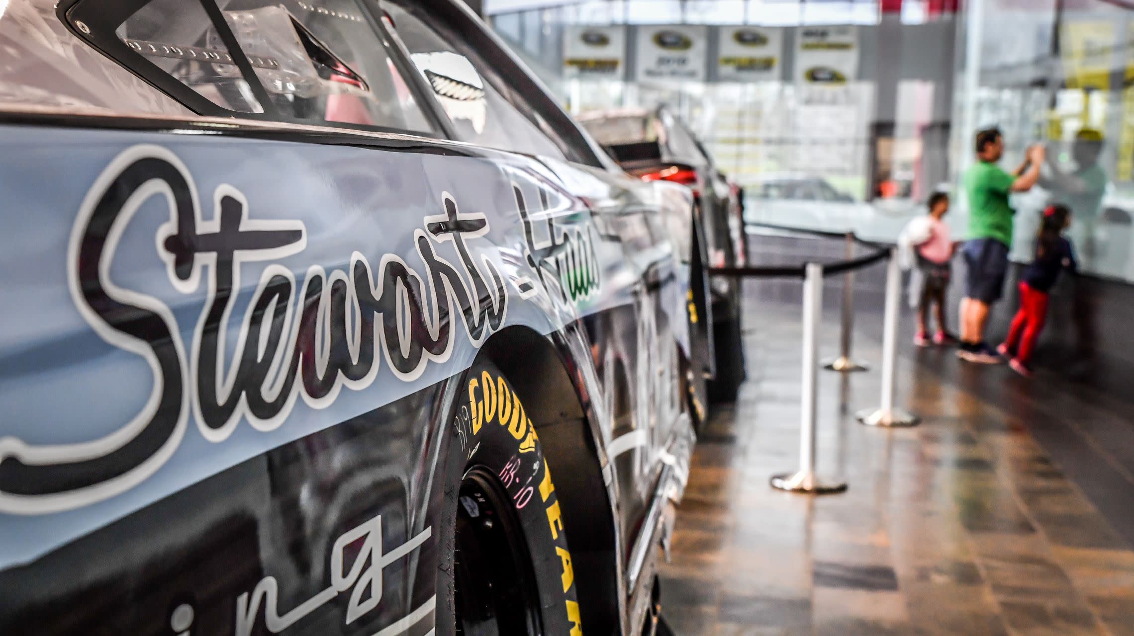 fans look into race shop viewing area