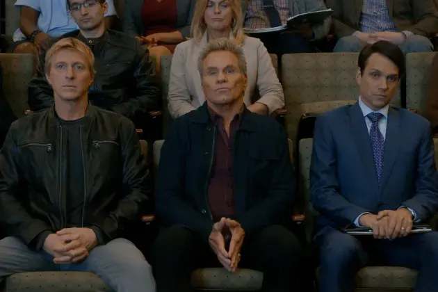  Still from Heald, Hurwitz, Schlossberg, Cobra Kai (Season 3, Episode 8). The three senseis sit together.