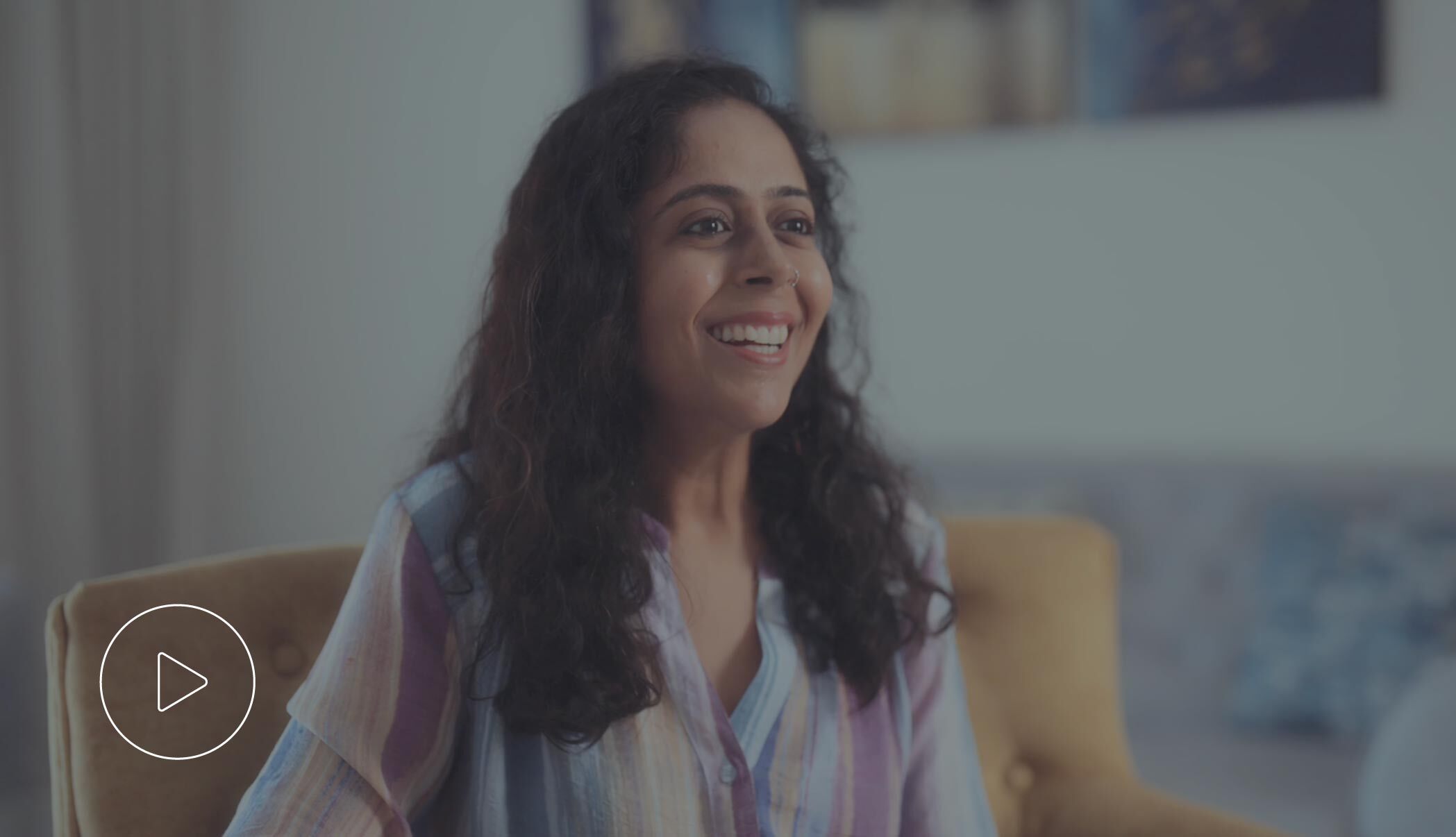 Woman smiling confidently in a professional setting.