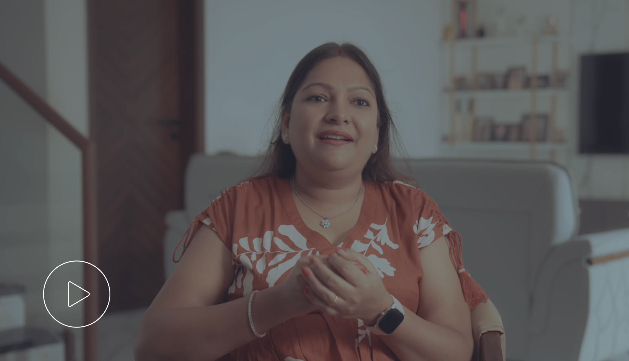 Woman smiling confidently in a professional setting.