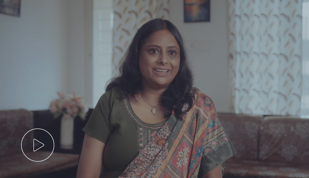 Woman smiling confidently in a professional setting.