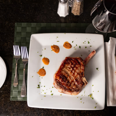 Lamb chop with salt and pepper shakers and utensils