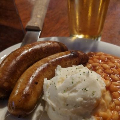 Bangers & Mash, sausage, beans and mashed potatoes closeup.