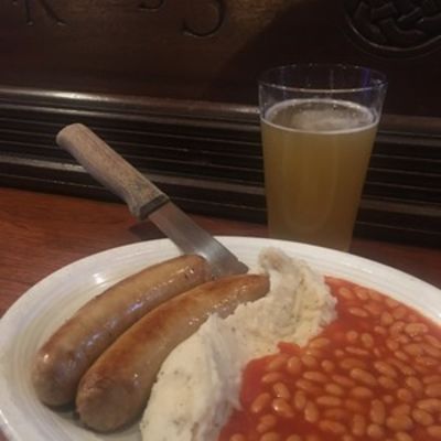 Banger's & Mash, sausages, mashed potatoes, beans and a glass of beer.