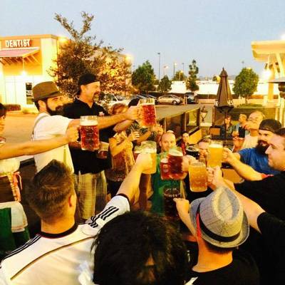 Oktoberfest crowd raising beer steins.