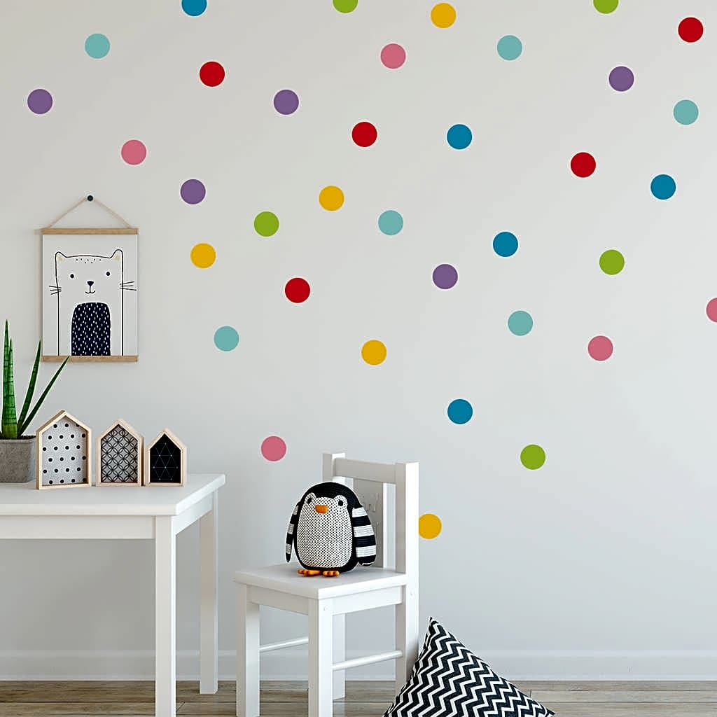 Colourful dot heat transfer vinyl on a white wall in a children's room with furniture