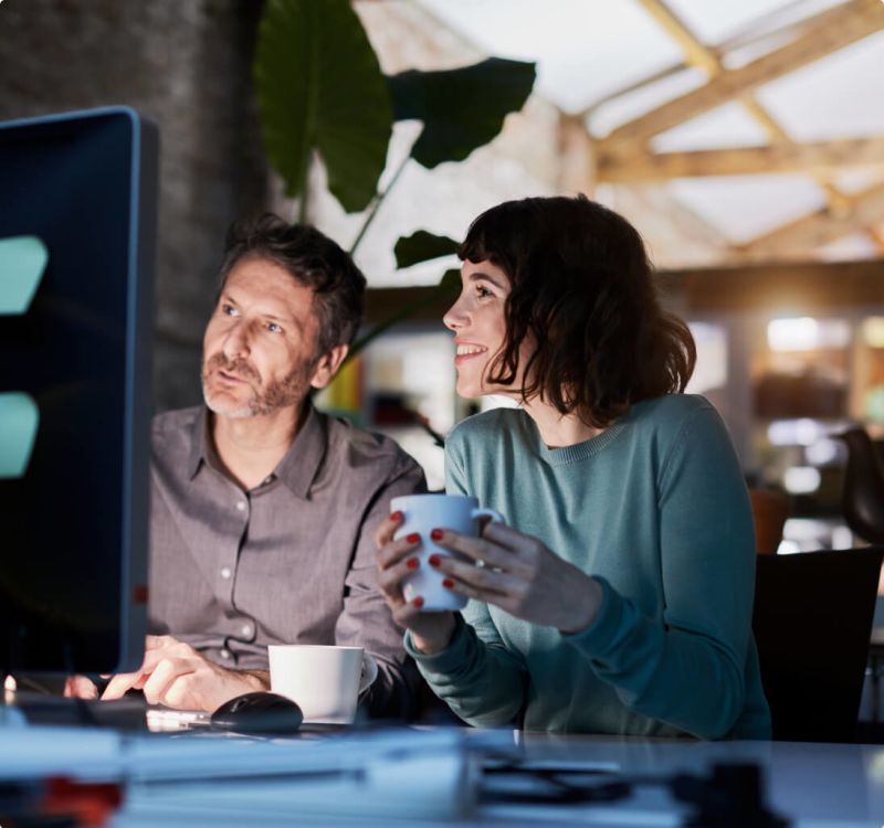 A man and a woman on a computer