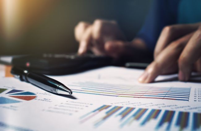 Close up pen on paperwork and woman hand calculate finance. Close up pen on paperwork and woman hand calculate finance.