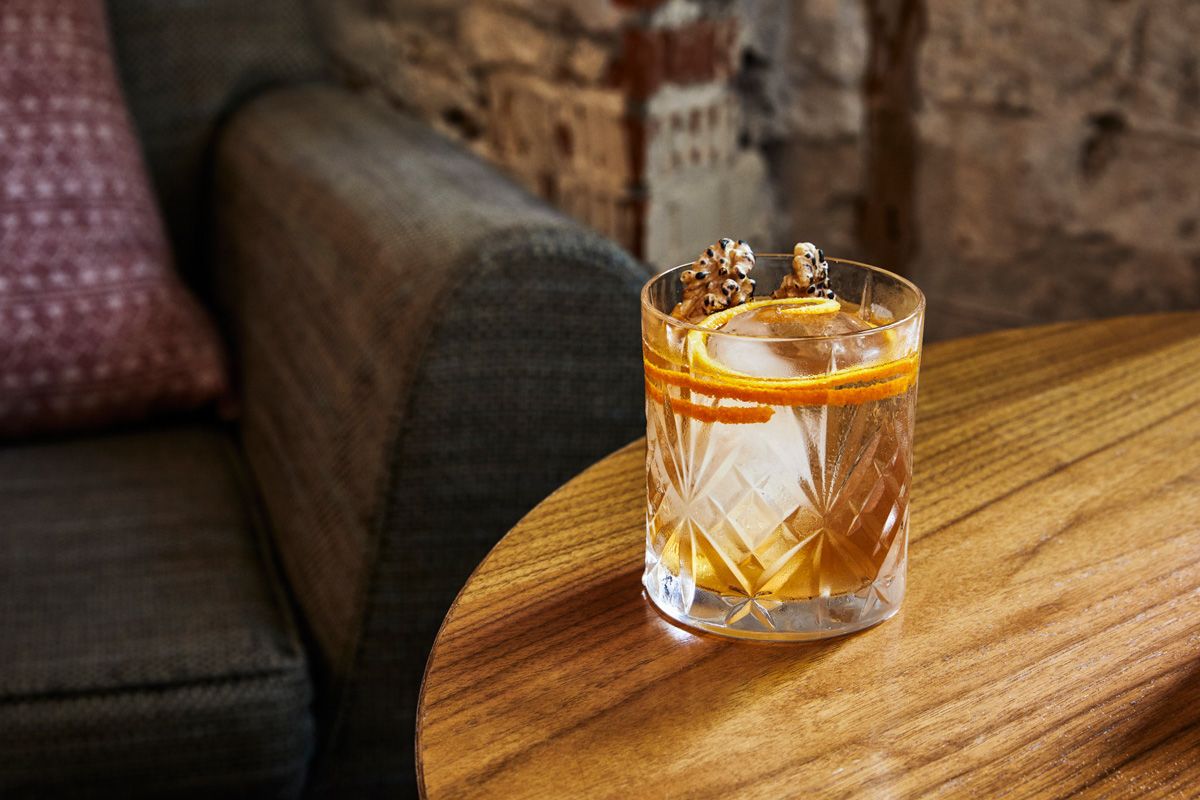 Cozy interior of top Amsterdam bar Lotti's, depicting a beautifully crafted cocktail