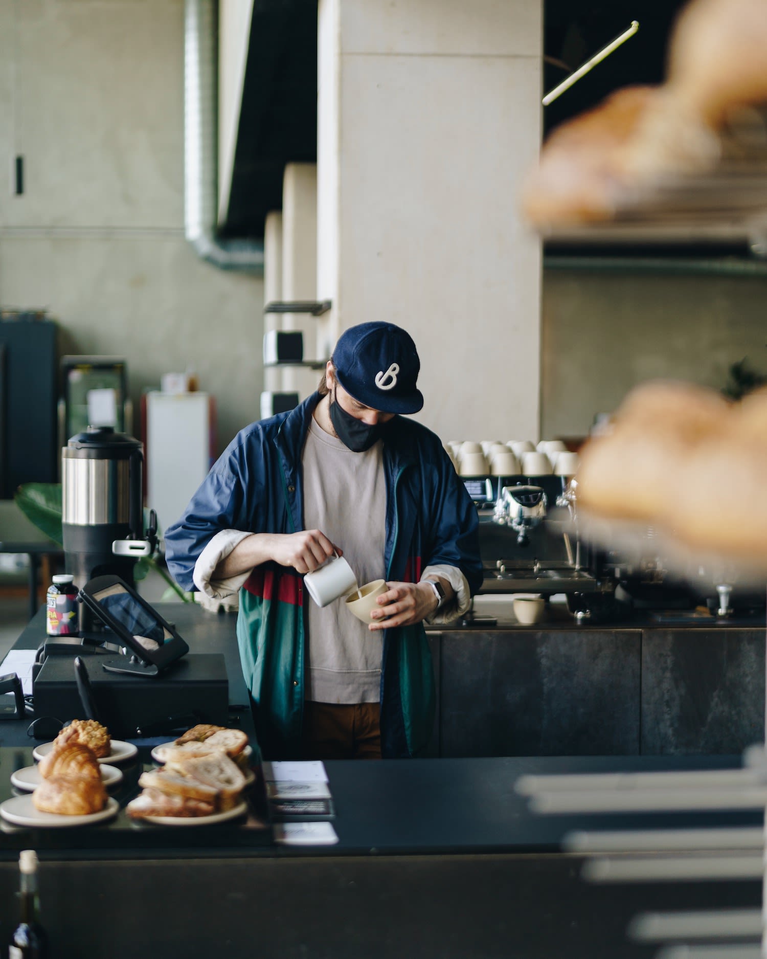 Amsterdam barista at Noord neighborhood Public Space makes delicious coffee drink