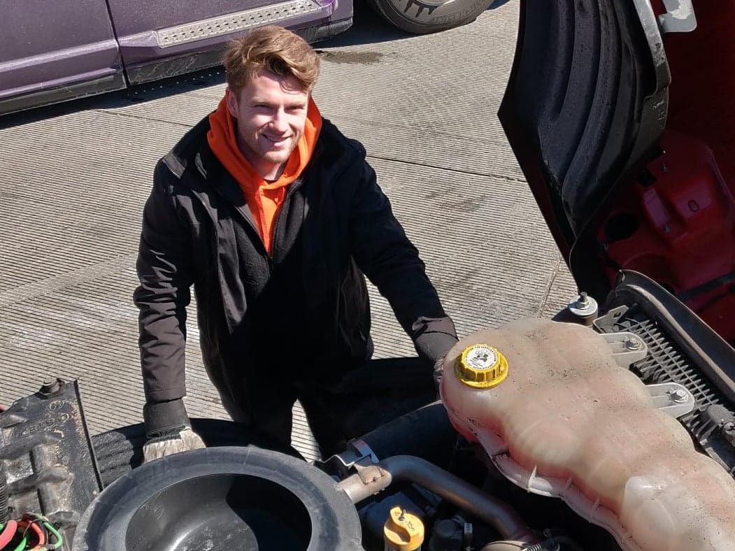 Joshua poses with his truck