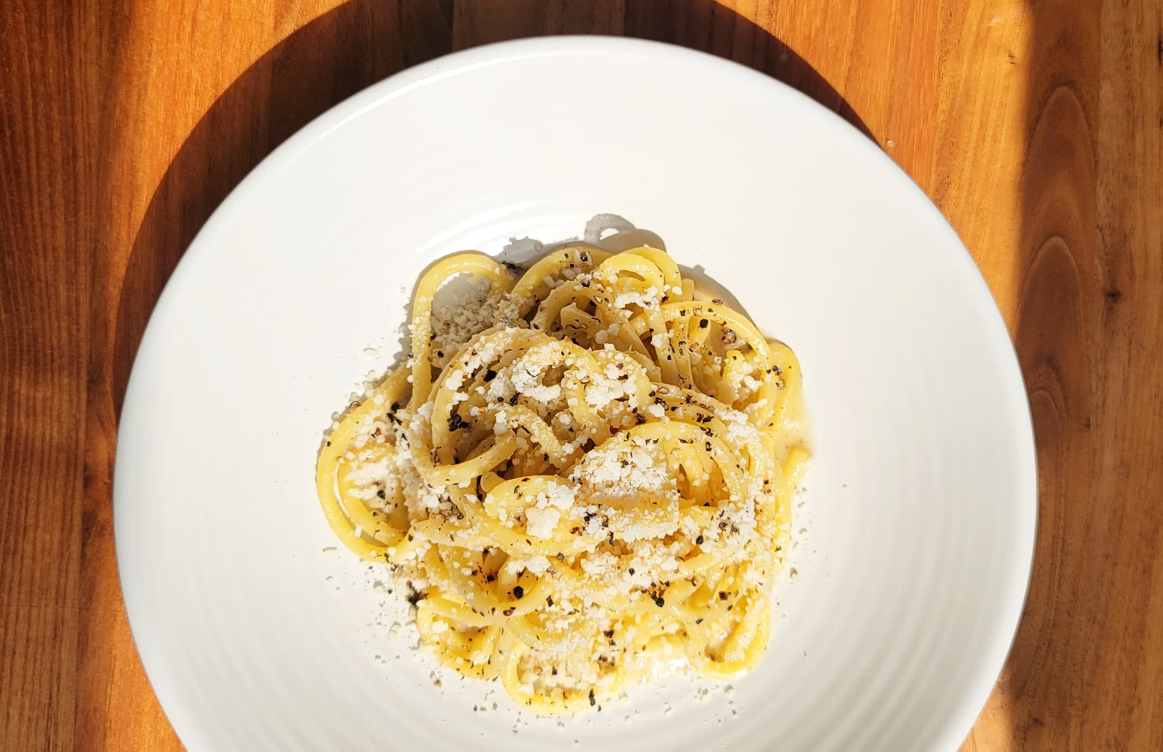 Chef Making Spaghetti Carbonara In Cheese Wheel With Tourched