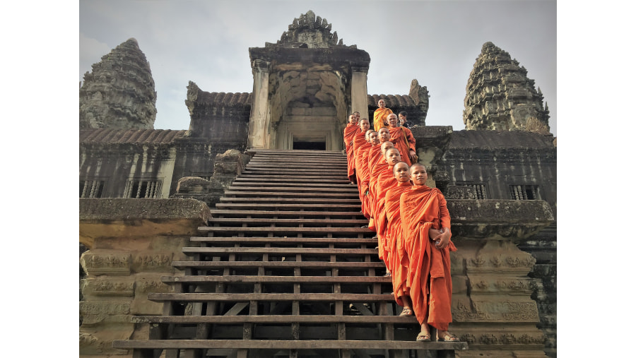 Monks standing at Ta Nie