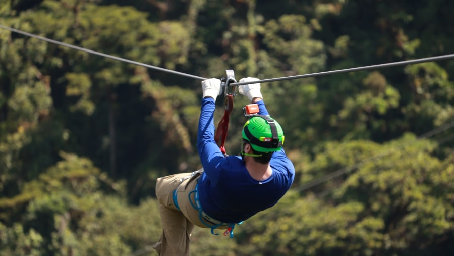 A Tourist Ziplining Through the Rainforest
