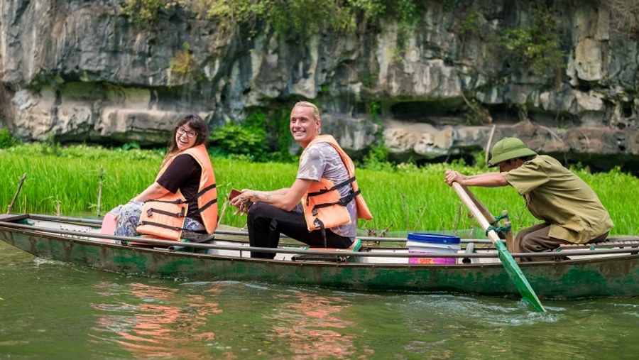 Tourists enjoying boat ride.