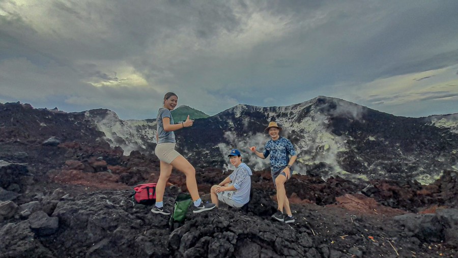 Resting at the edge of the crater of Mt Tavurvur Volcano after the climb