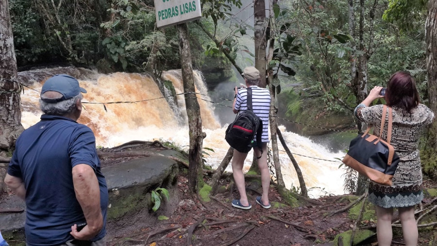 Tourists enjoying view of the waterfall