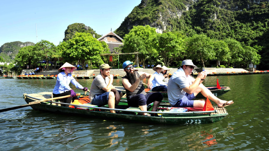 Tourists enjoying boat trip at Trang An 