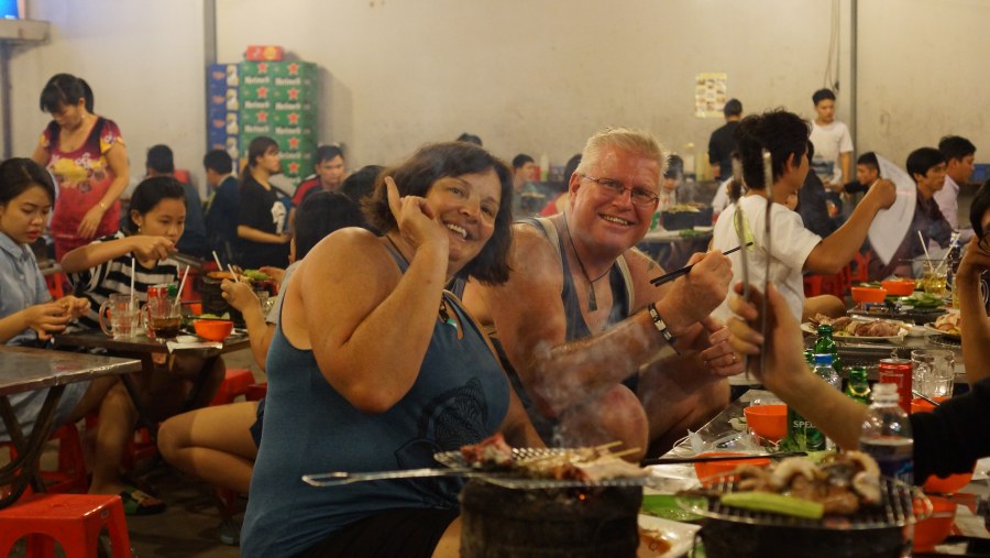 Tourists Enjoying Vietnamese BBQ at District 8