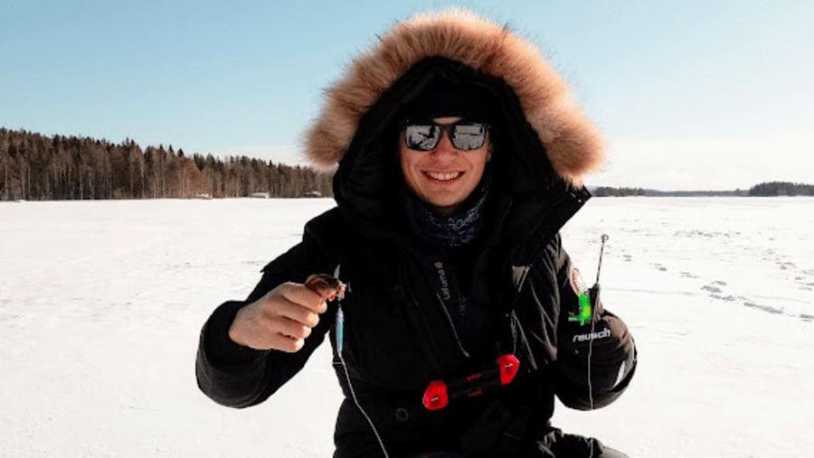 Ice fishing in lake Kitka, Kuusamo, Finland