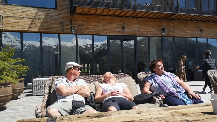 Tourists are enjoying sunbathing in Rooms Hotel Kazbegi