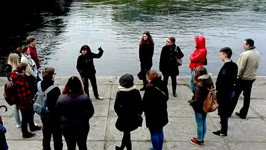 Tourists Listening to Ghost Stories from the Guide