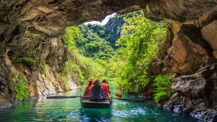 Exploring grotto in Trang An by bamboo boat in Ninh Bình