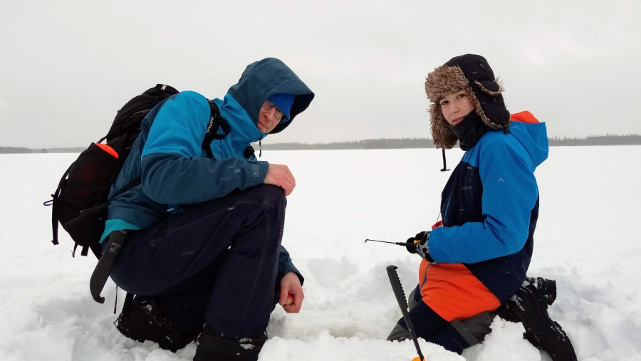 Ice fishing in lake Kitka, Kuusamo, Finland