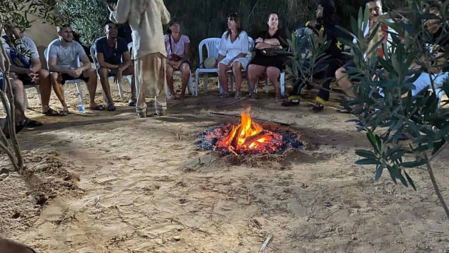 Travellers around a bonfire