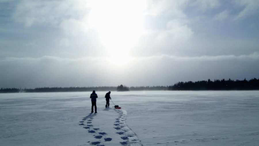 Ice fishing in lake Kitka, Kuusamo, Finland