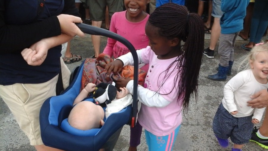 A Tourist and her child playing with Kindergarten kids