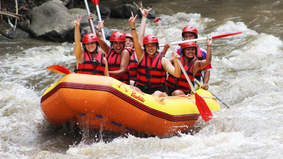 Tourists Enjoying River Rafting