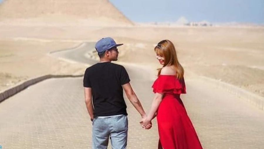 A couple in from of a Pyramid in Giza