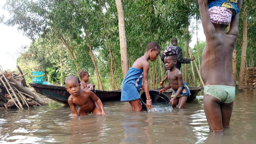 kids fetching water and taking bath in the river