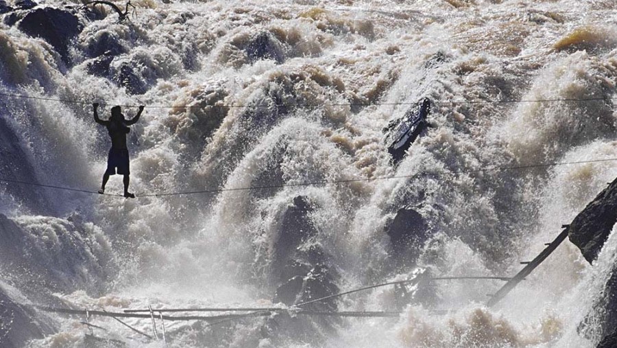 Crossing waterfall by single robe for fishing