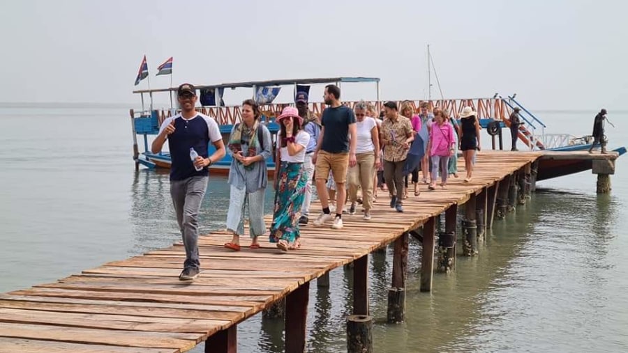 Disembarking from a boat walking to Kunta Kinteh island 