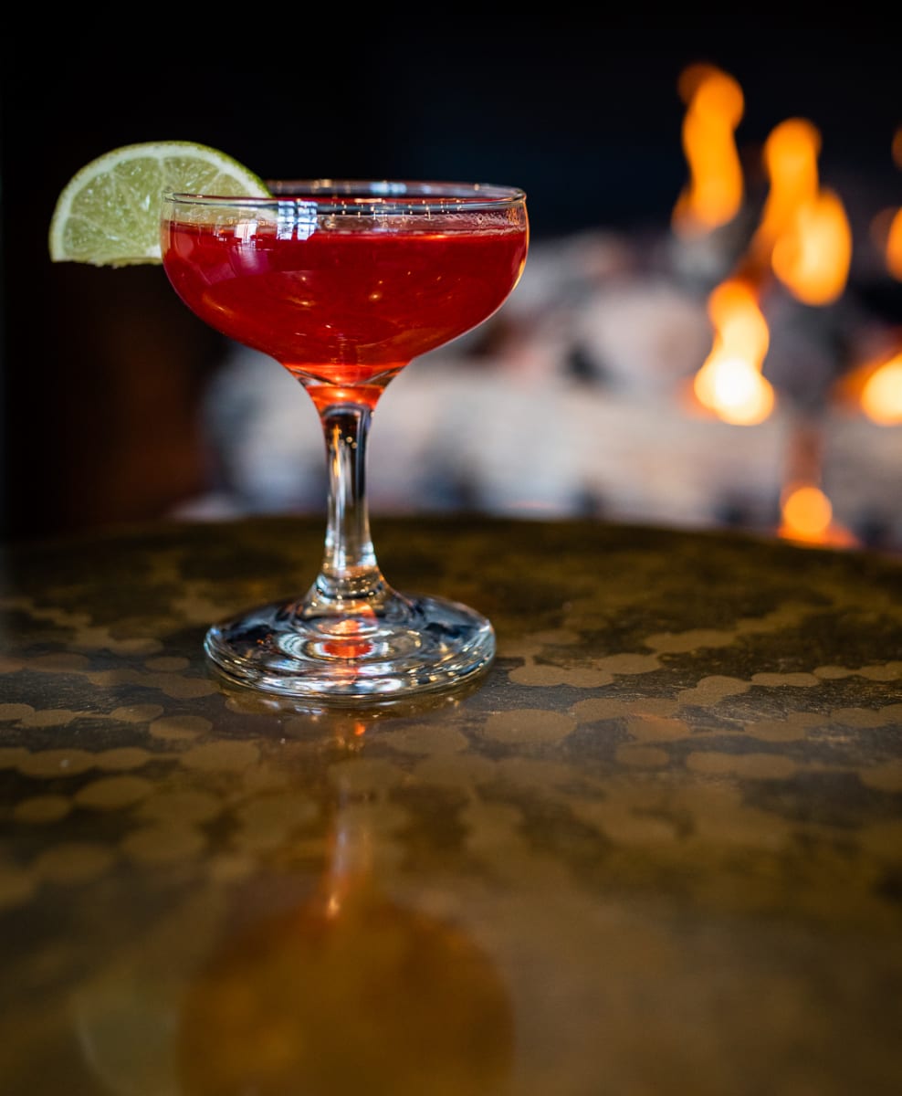 red cocktail in front of fire