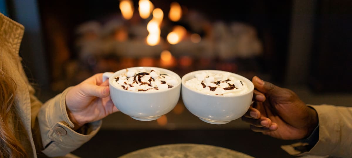 hot chocolate cheers in front of fire
