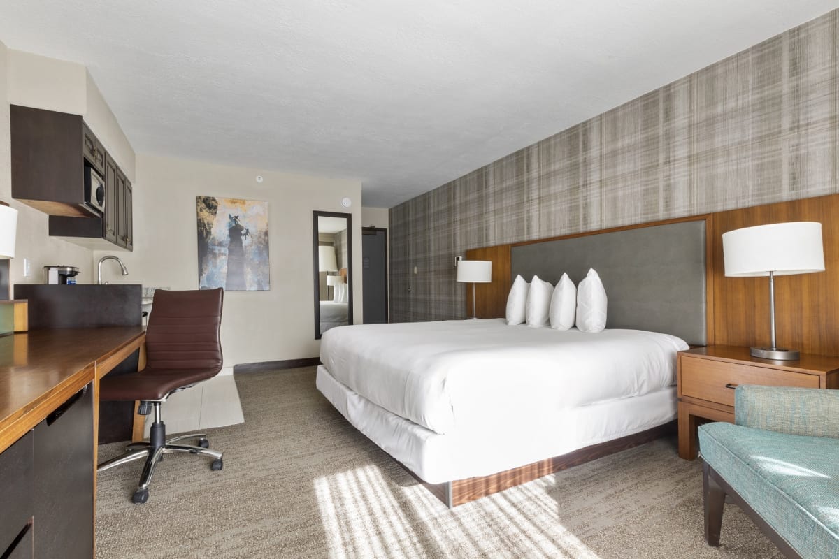 room with kind bed chair large desk