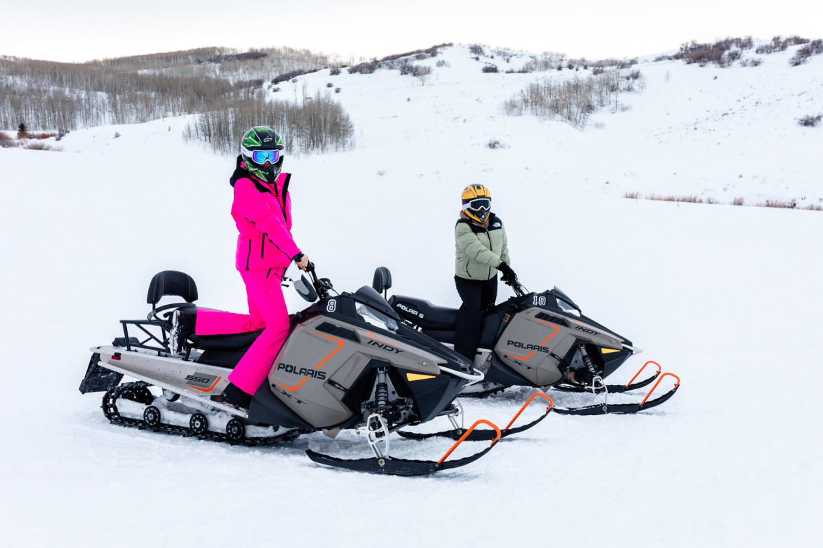 two people Snowmobiling