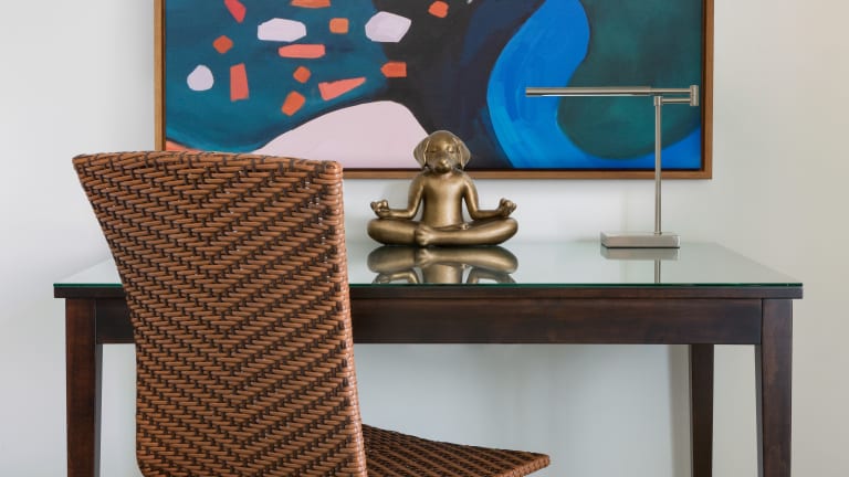 Marker Desk with a lamp and Dog Buddha placed on the desk.