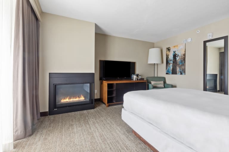 queen bed with fireplace and tv