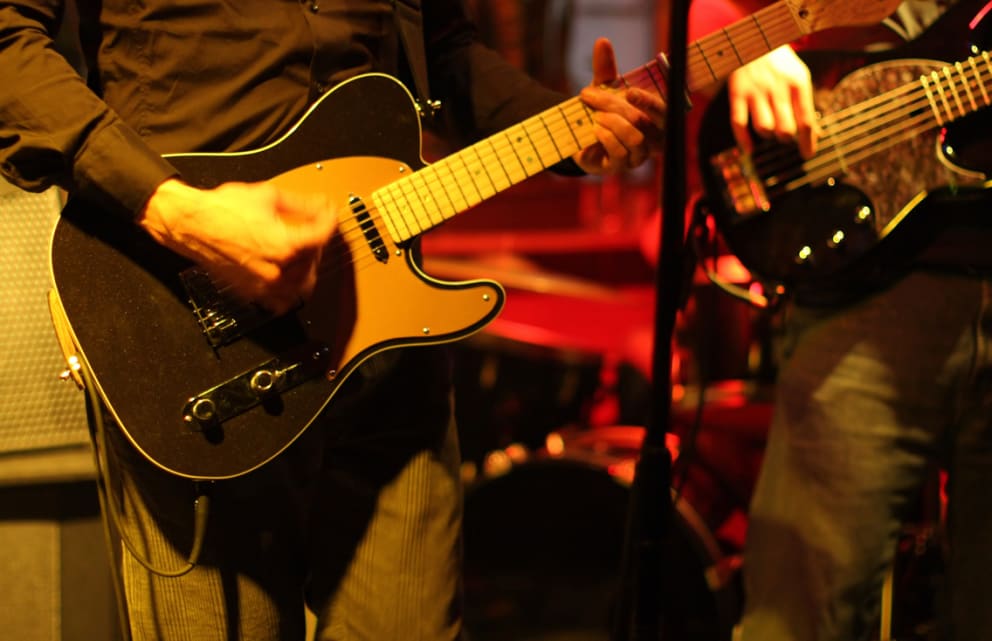 Two men playing guitar