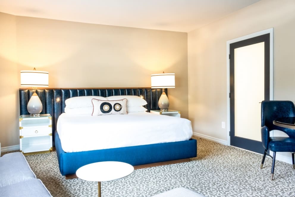 Studio King Suite with white bed and blue accents