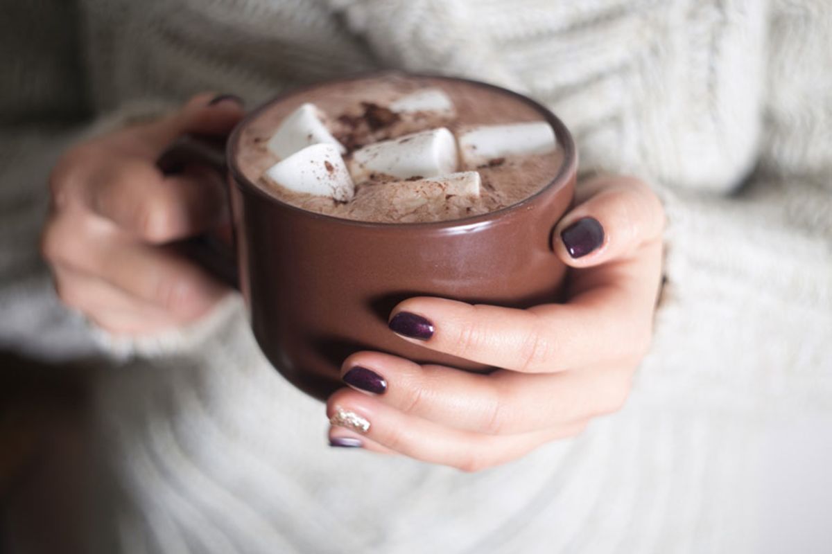 woman-holding-a-mug-of-hot-chocolate-with-marshmallows.